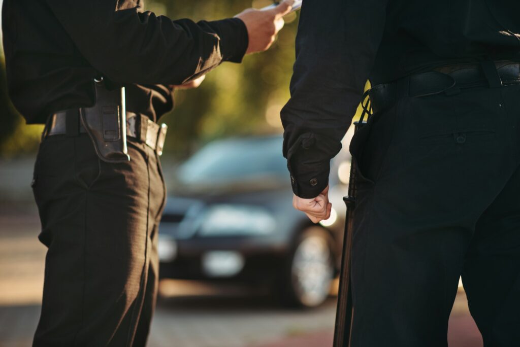 Cops in uniform check the car on road